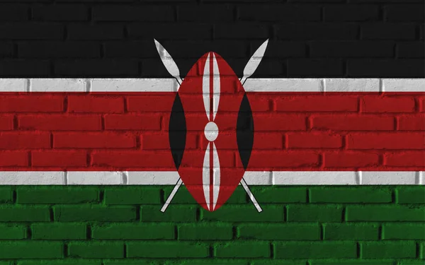 带有裂缝和具体概念的旧砖墙上的肯尼亚国旗绘画 — 图库照片