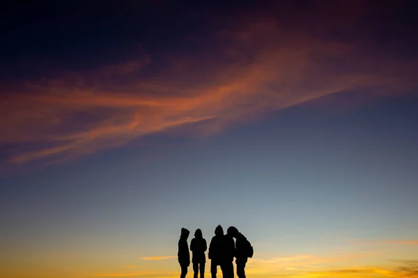 Silhouette of people at sunrise , let\'s travel to see the sunrise.