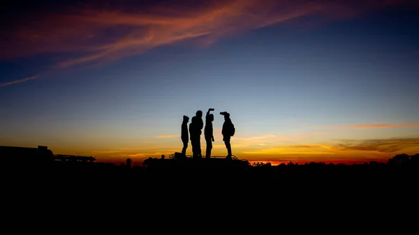 Silhouette of people at sunrise , let\'s travel to see the sunrise.