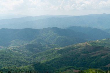 Mavi gökyüzü ve bulutlardan oluşan dağ manzarası 