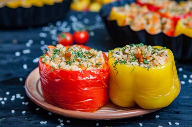 Doldurulmuş biber. Biberli pilav ve kıyma. Siyah arka planda, dökme demir bir tavada pişmiş biber. Sağlıklı Romanya yemekleri.