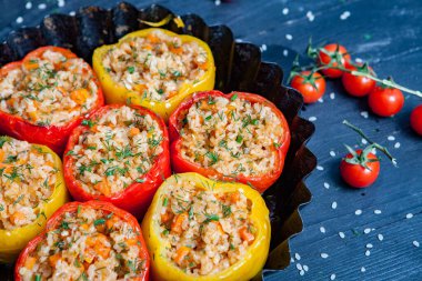 Doldurulmuş biber. Biberli pilav ve kıyma. Siyah arka planda, dökme demir bir tavada pişmiş biber. Sağlıklı Romanya yemekleri.