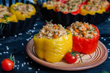 Doldurulmuş biber. Biberli pilav ve kıyma. Siyah arka planda, dökme demir bir tavada pişmiş biber. Sağlıklı Romanya yemekleri.