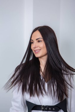 Beautiful young woman with long black hair in a beauty salon.close up of woman's hair in beauty salon, hairstyle concept