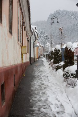 Rasnov, Romania  February 04 2023: It snowed beautifully in the medieval town of Rasnov in Romania.
