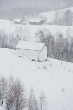 An abundant snowfall in the Romanian Carpathians in the village of Sirnea, Brasov. Real winter with snow in the country