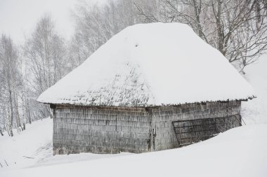An abundant snowfall in the Romanian Carpathians in the village of Sirnea, Brasov. Real winter with snow in the country