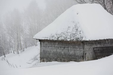An abundant snowfall in the Romanian Carpathians in the village of Sirnea, Brasov. Real winter with snow in the country