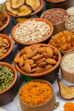 Sağlıklı vejetaryen gıda konsepti. Beyaz arka planda kurutulmuş meyve, fındık ve tohum çeşitleri. Üst görünüm.