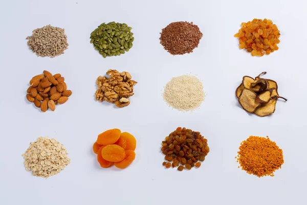 stock image Healthy vegetarian food concept. Assortment of dried fruits, nuts and seeds on white background. Top view.