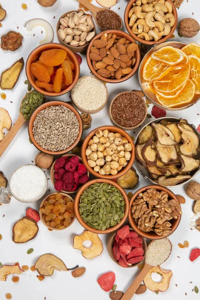 stock image Healthy vegetarian food concept. Assortment of dried fruits, nuts and seeds on white background. Top view.