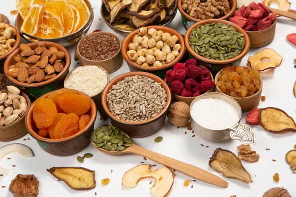 stock image Healthy vegetarian food concept. Assortment of dried fruits, nuts and seeds on white background. Top view.