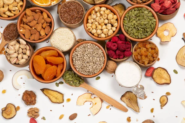 stock image Healthy vegetarian food concept. Assortment of dried fruits, nuts and seeds on white background. Top view.