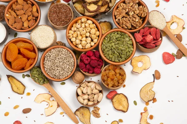 stock image Healthy vegetarian food concept. Assortment of dried fruits, nuts and seeds on white background. Top view.