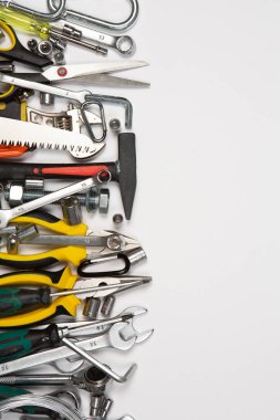 Beyaz arka plandaki bir çantada tamir için gerekli aletler. Çeşitli iş ya da inşaat aletleri. Anahtarlar, pense, tornavida. Üst görünüm