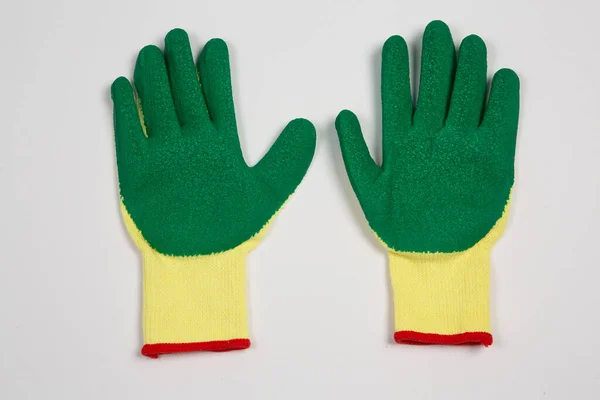 Rubber gloves isolated on white background. Green and red rubber gloves.
