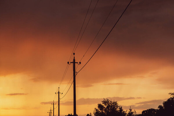 High-voltage power lines at sunset. Electricity distribution station. electricity pylons on the background of the sky