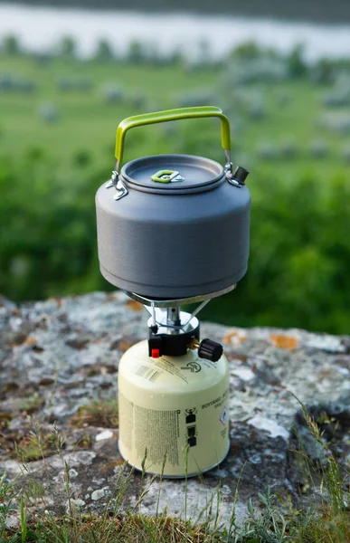 Camping gas burner on a rock. Camping equipment in the nature.