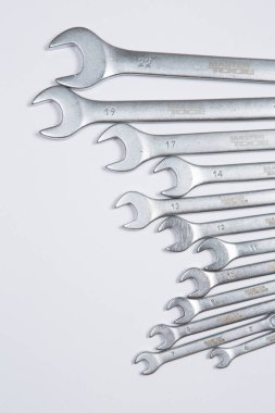 Beyaz arka plandaki bir çantada tamir için gerekli aletler. Çeşitli iş ya da inşaat aletleri. Anahtarlar, pense, tornavida. Üst görünüm