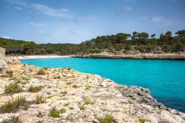 Güzel gün batımı plaj manzarası, egzotik tropik ada doğası, mavi deniz suyu, okyanus dalgaları, renkli kırmızı gökyüzü, Mallorca, İspanya 'da yaz tatili