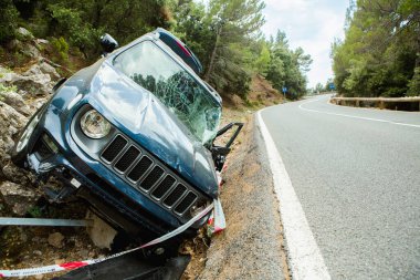 Palma de Mallorca, İspanya 22 Temmuz 2023: İspanya 'nın Mallorca kentindeki bir dağ yolunda meydana gelen ciddi bir kazanın ardından omuzunda oturan yaralı bir cip