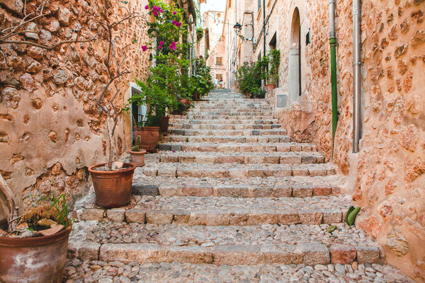 View of a medieval street in the Old Town of the picturesque Spanish-style village Fornalutx, Majorca or Mallorca island