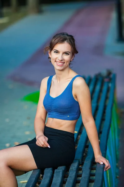 Athletic young woman in sportswear jogging in the park. Fitness and healthy lifestyle. Portrait of a beautiful young woman in sportswear outdoors. Sport fitness model caucasian ethnicity training outdoor.