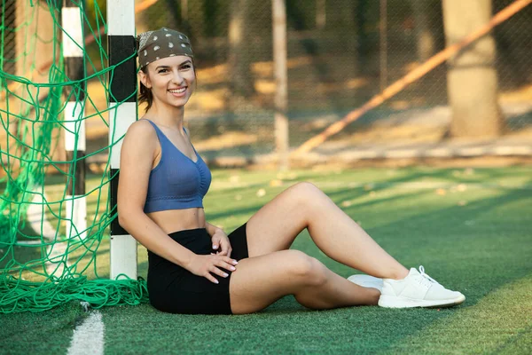 Athletic young woman in sportswear jogging in the park. Fitness and healthy lifestyle. Portrait of a beautiful young woman in sportswear outdoors. Sport fitness model caucasian ethnicity training outdoor.