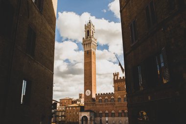 Beautiful colored and medieval street in the old town of Siena, Italy clipart