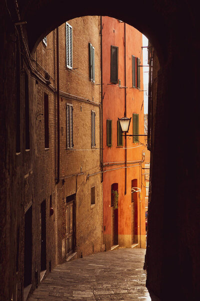 Beautiful colored and medieval street in the old town of Siena, Italy