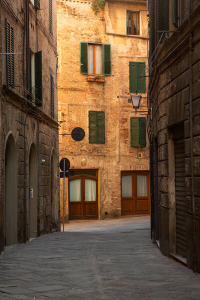 Beautiful colored and medieval street in the old town of Siena, Italy