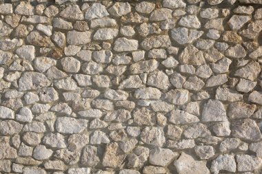 Taş duvar dokusu fotoğrafının arka planı. Taş duvara yakın çekim.