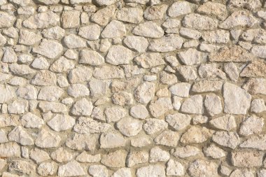 Taş duvar dokusu fotoğrafının arka planı. Taş duvara yakın çekim.