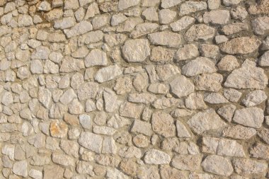 Taş duvar dokusu fotoğrafının arka planı. Taş duvara yakın çekim.