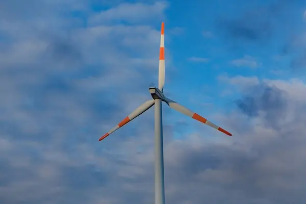 stock image Wind turbine on the background of the blue sky. Clean renewable energy. Electric power production.