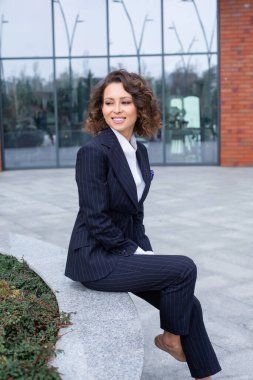 Modern iş binasının önünde başarılı bir iş kadınının portresi. Genç yönetici dışarıda poz veriyor. Kadın iş adamı.