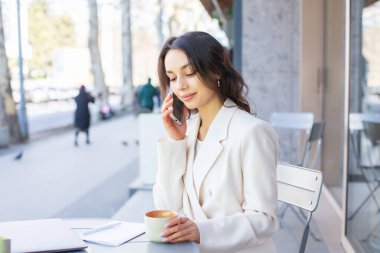 Şehirdeki modern bir kafede genç bir blogcu ya da nüfuzlu biri telefonda konuşuyor. Başarılı Girişimci ya da İş Kadını Açık Cafe 'de bir dizüstü bilgisayarda çalışıyor.
