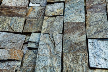 Taş duvar. Dekorasyon için taştan bir arka plan. Tasarım için doku. Granit çakıl taşı dokusu