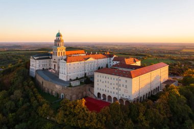 Aerial view about the Benedictine Archabbey of Pannonhalma. This is the second largest territorial abbey in the world. Hungarian name is Pannonhalmi Bences Foapatsag. Autumn sunrise landscape.