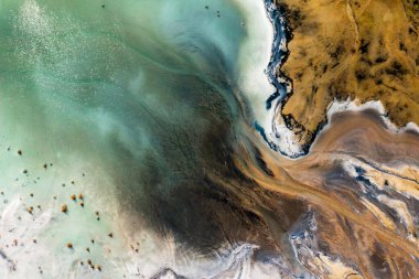 Aerial view of the famous red mud disaster site, abstract lines, surreal landscape, icelandic feeling.