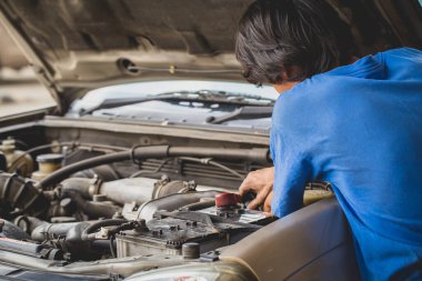 Broken car. male hand repairing a car engine.