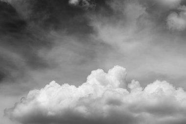 black and white with fluffy white cloudy in the sunset.