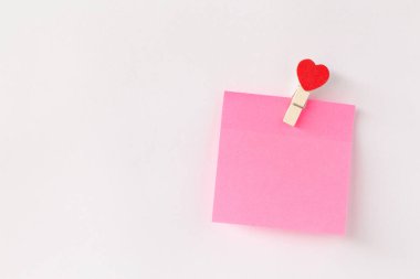 Abstract of wooden heart clip with Blank paper and stick paper on refrigerator door. paper note copy space for add text.