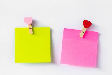 Abstract of wooden heart clip with Blank paper and stick paper on refrigerator door. paper note copy space for add text.