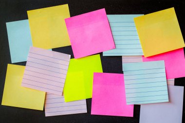 Abstract empty sticky note, isolated on black background.