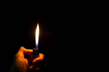 abstract Motion Hand with lighter igniting sparks on dark background