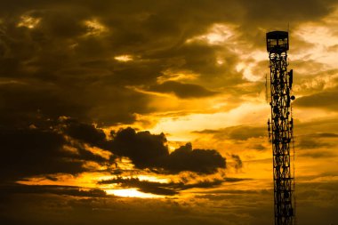 orange sunset sky with dark cloudy. Beautiful sky with tower.