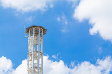 telecommunications tower with blue sky clouds background