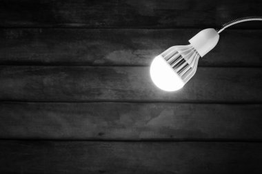 abstract hanging white lamp with old wooden wall background.