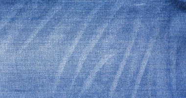 Abstract Jeans with torn marks. Retro colour tone of blue denim jeans fabric texture for background website fashion design or backdrop product.